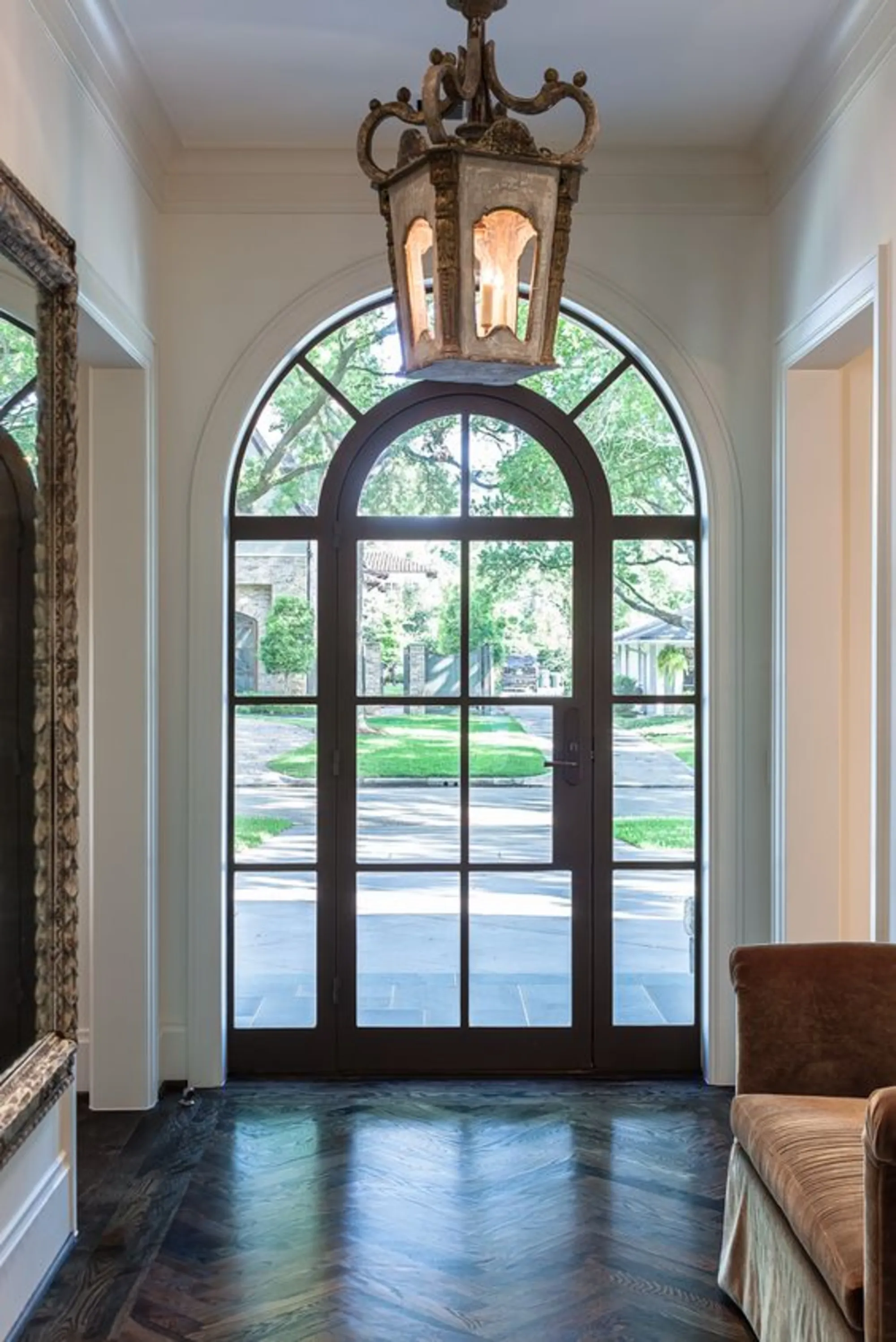 Elegant entryway with arched glass double doors and decorative grilles, showcasing the detailed anatomy of a window and door design