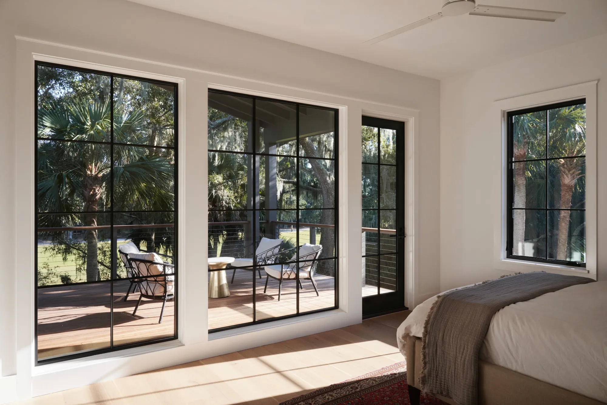 Modern bedroom windows with black frames providing natural light and ventilation, meeting legal bedroom window requirements