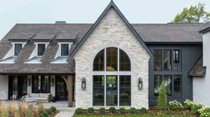 Image of a stone home exterior with an arched window that shows how replacing windows can increase home value